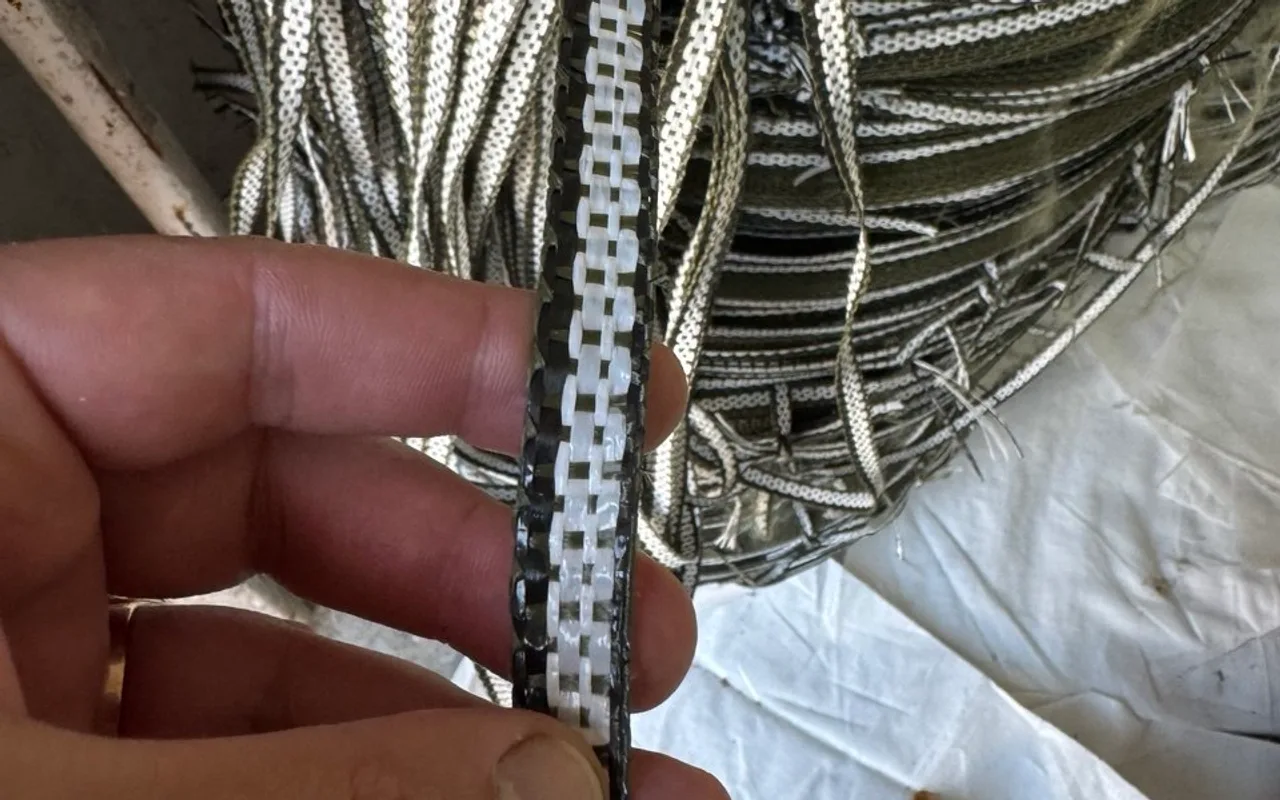 Big bag lifting webbing in hand — its weave determines the safety factor